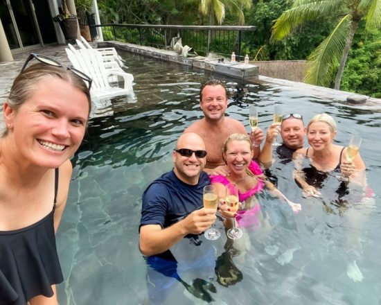 Casa de Sofia guests enjoying champagne in the pool