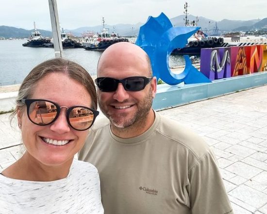 Casa de Sofia guests by the Manzanillo sign