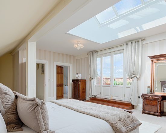 Birchwood Estate Master Bedroom with View of Deck and Skylights
