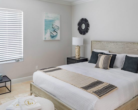 Blue Island Villa bedroom with neutral accents and boat painting