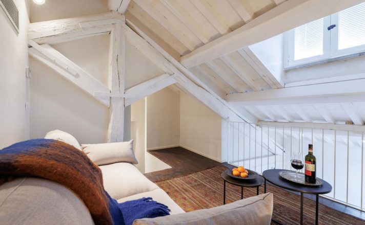 A small lounge loft offers a comfy couch and sunlight