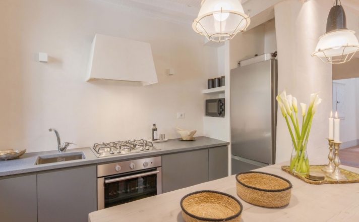 Bella Aura features a small but modern kitchen with sleek stainless steel appliances