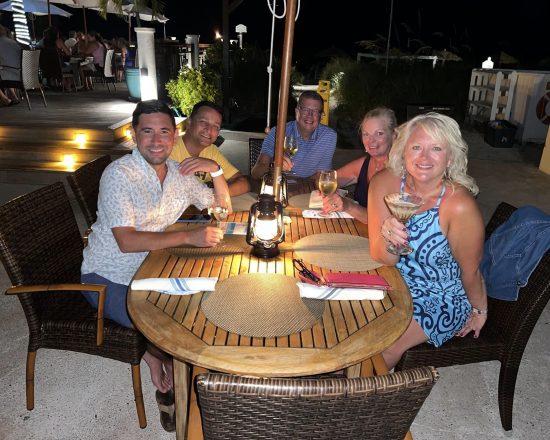 Blue Island Villa guests enjoying drinks at night on the patio