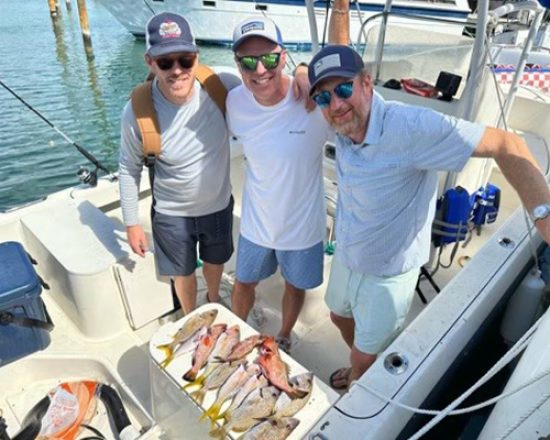 Blue Island Villa guests on a fishing charter showing off their catch