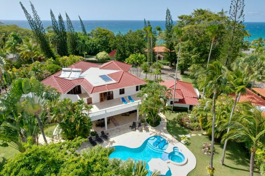 Overhead view of Cabarete Dreams property in the Dominican Republic, showing the home and the pool surrounded by lush greenery with the ocean in the background