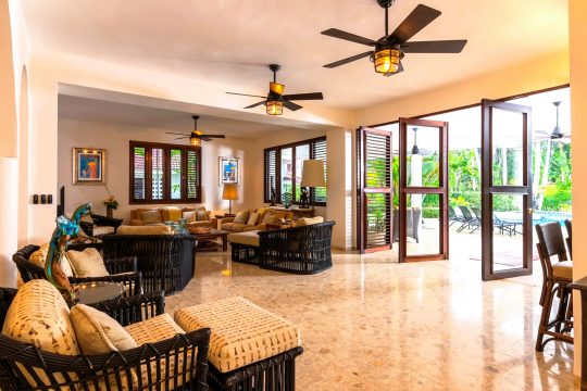 Beautiful living room at Cabarete Dreams, which features large glass doors that open to let in the breeze