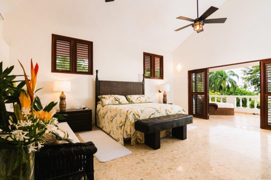 Master bedroom at Cabarete Dreams, featuring a walk-out patio and sliding doors