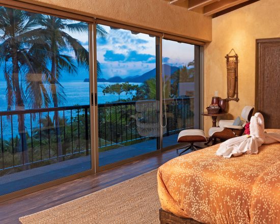 Casa de Sofia bedroom with solid glass wall and seating area