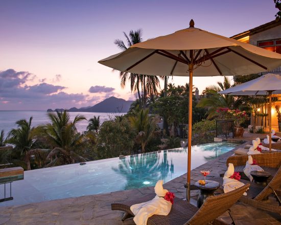 Casa de Sofia infinit pool at dusk with the patio lights lit