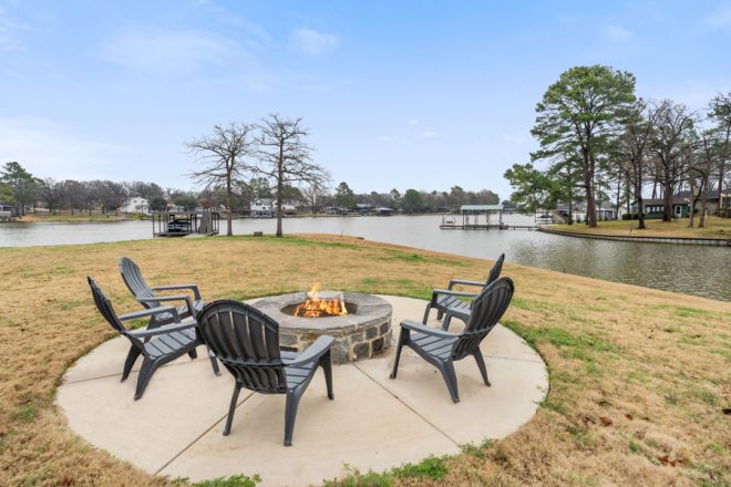 Firepit area at Cedar Creek, which features a paved area for chairs plus a built-in firepit. It looks out over the water.