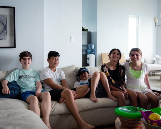 Blue Island Villa guests posing in the living area