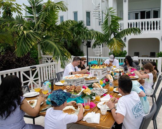 Blue Island Villa guests dining outdoors at the large table