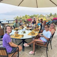 Guests enjoying dinner outdoors at Blue Island Villa