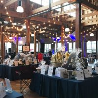 Silent auction items set up on tables for a charity fundraiser