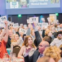 Guests bidding for items at a charity auction